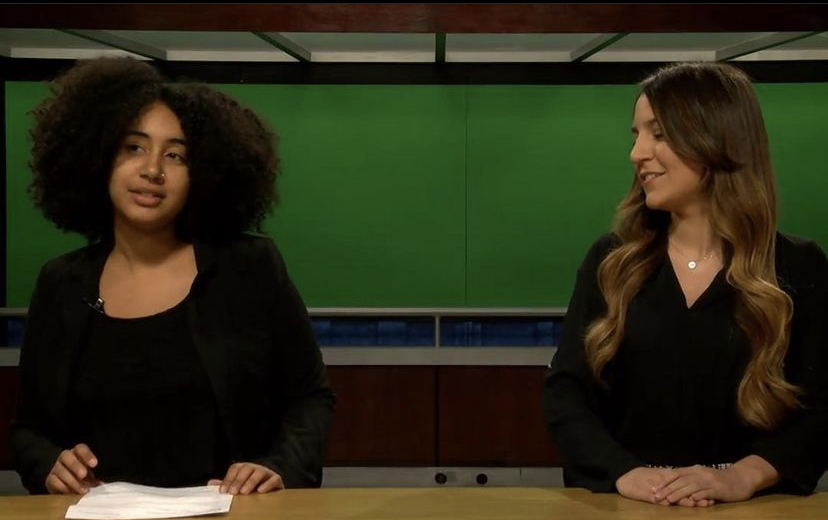 Photo of Erica filming a mock newscast